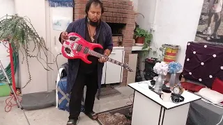 Al-Masih Wonderwiesse playing guitar with broken left hand after punching Satan in the Face, broken