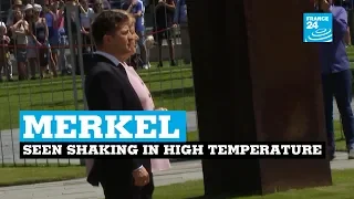 Angela Merkel seen shaking during ceremony in Berlin