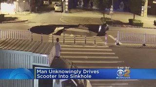 Man Unknowingly Drives Into Sinkhole