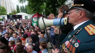 Ukrainians march with photos of their veteran relatives on Victory Day