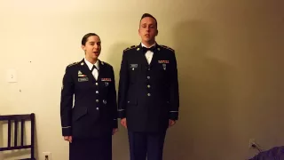 Husband and wife soldiers sing National Anthem