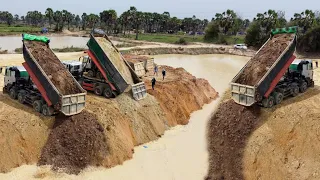 Great Fill up land! Processing Dump truck unloading soil with Dozer D31E PushingSoil drop into water