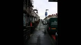 Idiot builder throwing bricks off a roof