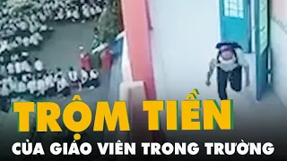 Camera quay lại cảnh người đàn ông lom khom chui vô trường trộm tiền của giáo viên
