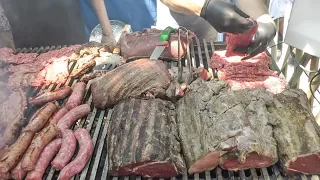 Huge Blocks of Beef, Ribs and Sausages on Grill. Street Food of Italy