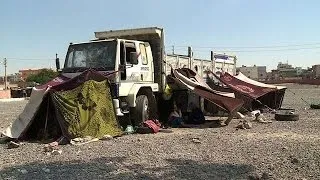 Syrian refugees receive food aid in makeshift Turkish camp