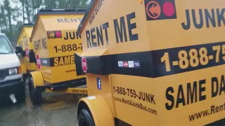Delivering a Junk Bus Small Dumpster Rental in  New Orleans While it is Raining