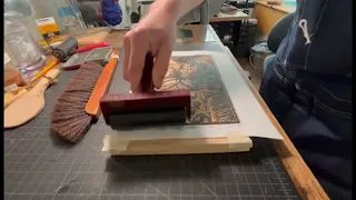 Inking a wood block for printing