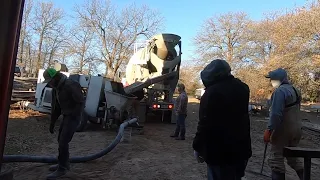Trailer pumping concrete into a barn. Pumping concrete with Muddyfeet