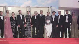 The cast of David Cronenberg's Crimes Of The Future poses at the Cannes red carpet