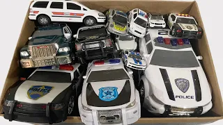 A Box Full of Police Cars Mini Car Run on a Slope in Pairs for Emergency Lined Up Checked One by One
