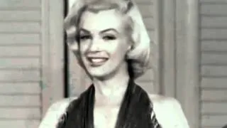 Marilyn Monroe receiving an award from Fred Sammis