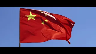 CHINESE FLAG WAVING IN THE WIND AGAINST A BLUE SKY 4K