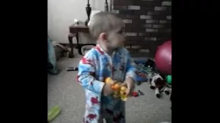 Toddler copies Lion King movie and holds up his Simba toy