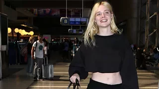 Elle Fanning Flashes Her Abs At LAX