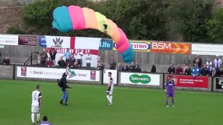 Parachutist lands on pitch during game