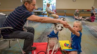 Watch kids read to dogs in Carmichael library