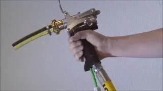 Single handed gun for application of bonding mortars and spraying of basecoat mortars