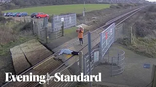 Moment 'unthinkably stupid' woman lies on railway track to pose for photograph