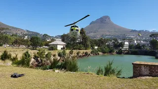Four fire fighting helicopters refilling their buckets in a row. Cape Town, South Africa