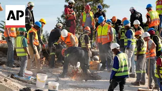 Rescuers work in the rubble after deadly building collapse in South Africa