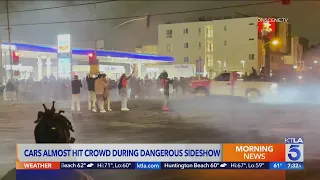 Cars nearly hit crowd during dangerous street takeover