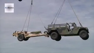 CH-47 Chinooks Airlifting M119 Howitzers