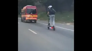 Man riding electric scooter on motorway highway