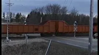 CNW 6848 West passes through the wig-wags on the Adams line/GECX Super 7 and 2 GP7s