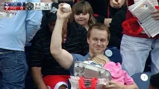 Fan grabs foul ball while holding his child