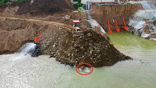 A 25-ton truck hauls Rocks over the riverbank for construction and development By Bulldozer pushing