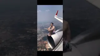 Man rides jet engine on moving plane