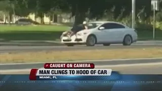 NOW TRENDING: Man clings to hood of car during road rage incident