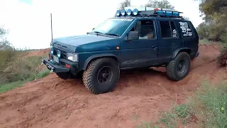 WD21 Nissan Pathfinder on 4x4 offroad track with deep ruts.