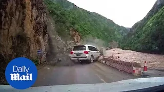 Terrifying rockslide almost crushes car on narrow mountain road