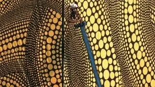 Installation of Yayoi Kusama's Yellow Trees building wrap