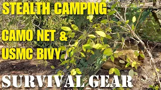 Stealth bushcraft camping test setup with camo net and bivy