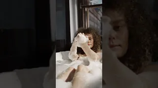 A Girl Playing With Bubbles While Soaked In A Bathtub