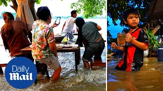 Restaurant in Thailand floods but defiant owner keeps it open