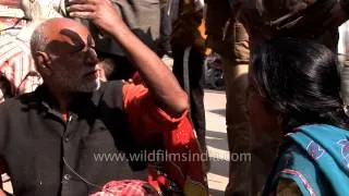 Roadside dentist works on a patient dentures