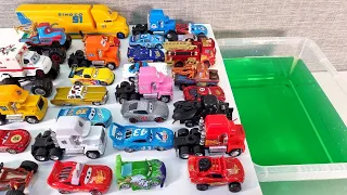 Diecast model cars and truck sliding into water