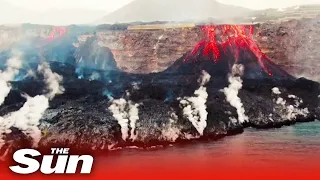 Epic volcano drone footage of lava streaming into sea