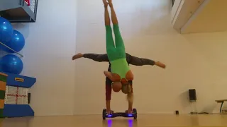 Upside Down Woman Holds Onto Guy as He Performs Handstand on Hoverboard - 1244843