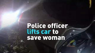 Police officer lifts car to save woman