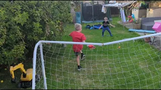 The boys are playing football. Think the gloves might be a bit big