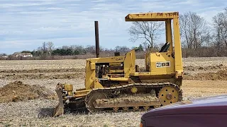 1976 Cat D3 dozer cutting in a driveway