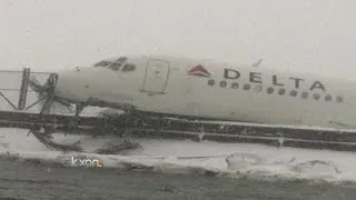 Plane skids off runway at LaGuardia, crashes through fence