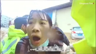 The moment a woman was saved from rushing flood waters in China