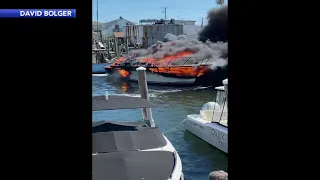 Video captures raging boat fire in Ottens Harbor in Wildwood, New Jersey