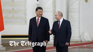 Putin meets with Xi Jinping as he vows response to UK's supply of depleted uranium shells to Ukraine